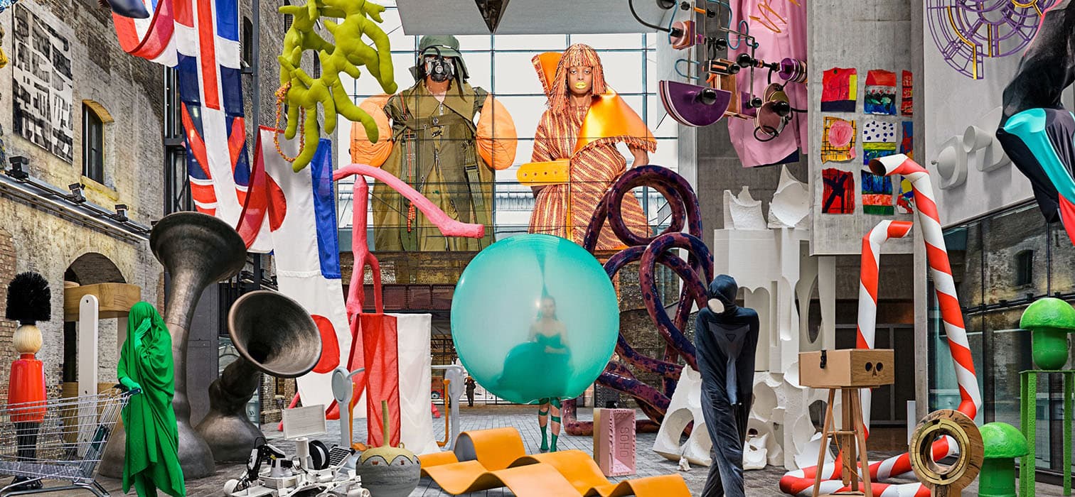 Avant-garde design studio installation filled with colorful sculptures, experimental craft, and oversized mixed media