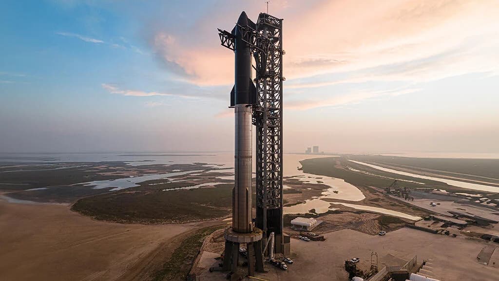 A fully stacked rocket held inside its integrated launch tower at dawn, an image of tightly coupled vertical engineering